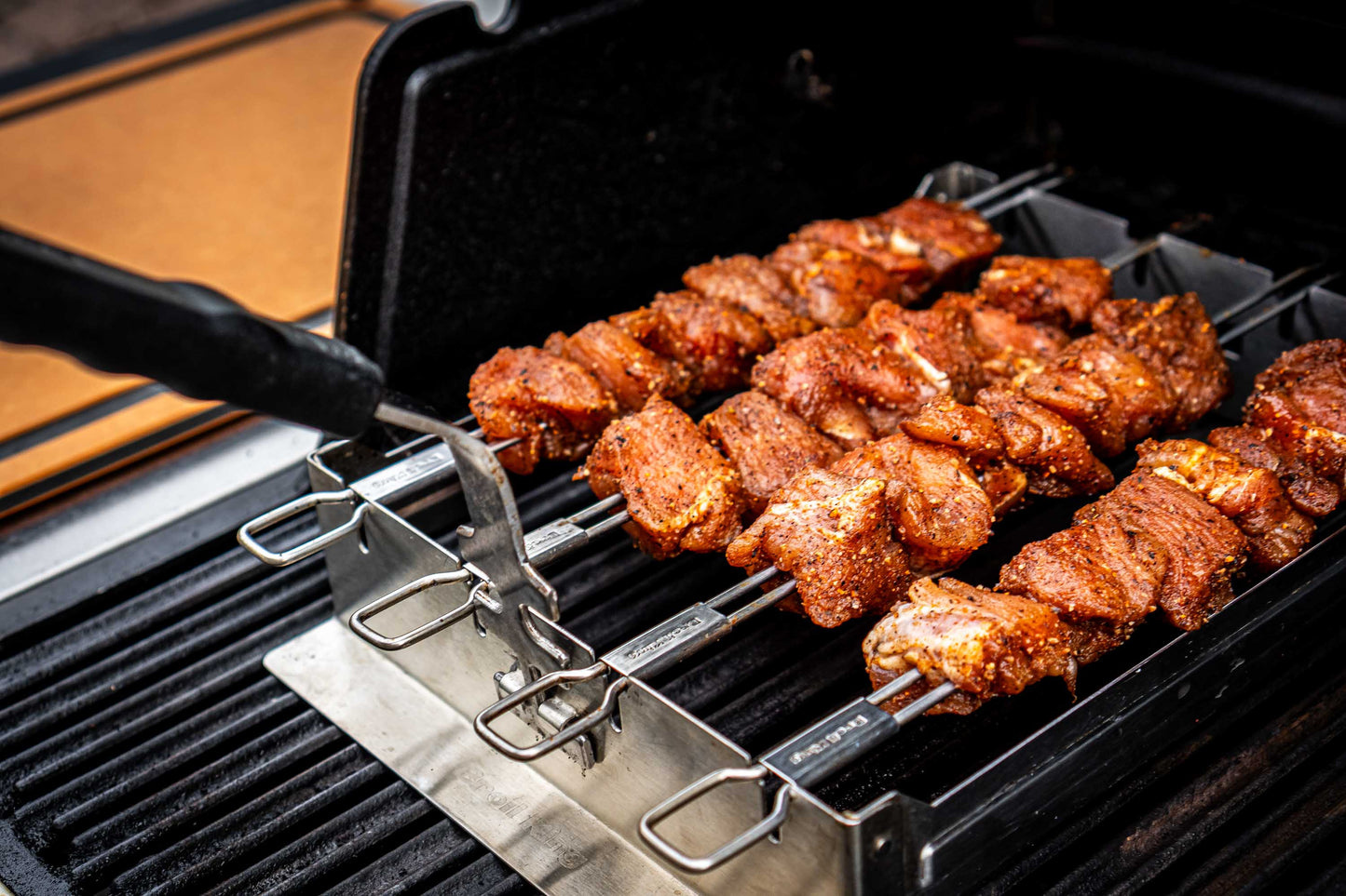 Skewers of marinated meat cooking on a grill