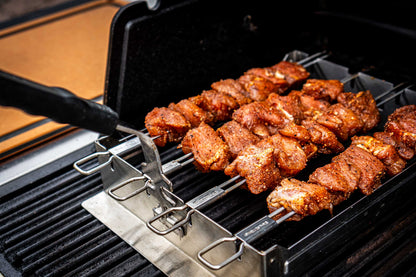 Skewers of marinated meat cooking on a grill