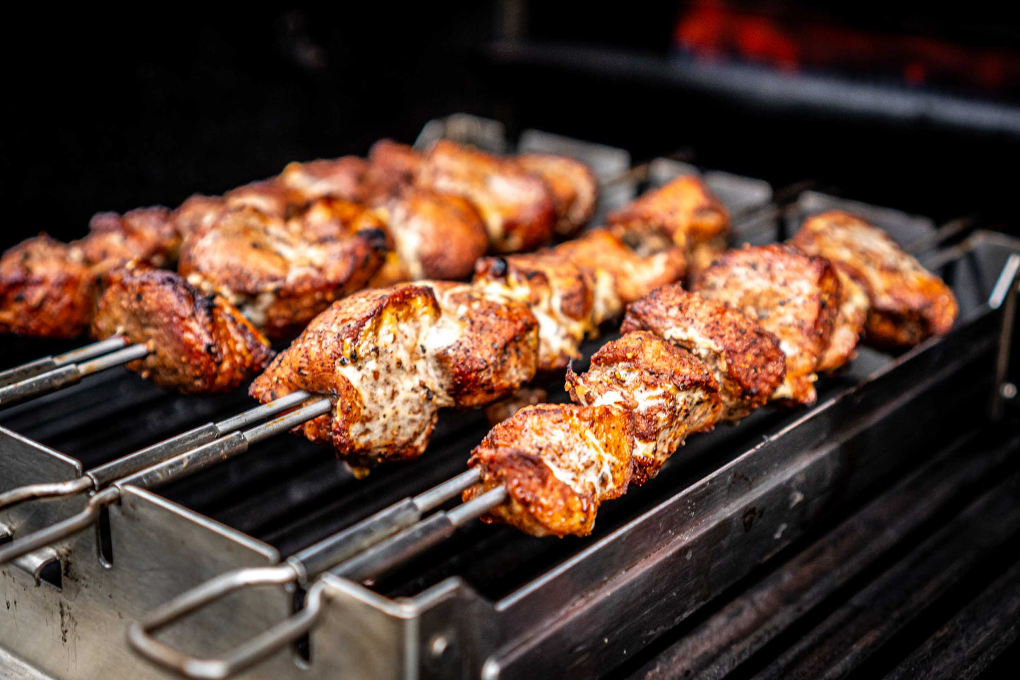 Skewers of grilled meat on a barbecue grill